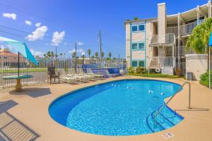 a swimming pool in front of a apartment building at La Internacional 313 in South Padre Island