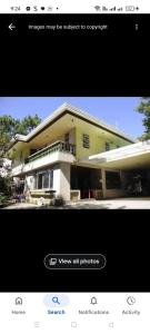 a picture of a yellow house with a view all photography at Jenny's transient house in Baguio