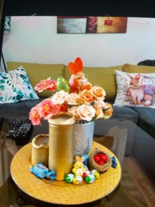a table with a vase with flowers on it at Happy M&S in Šabac