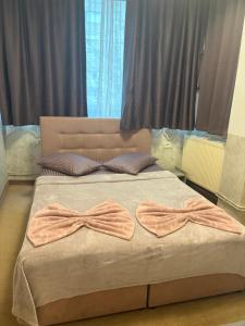 a bedroom with a bed with two bows on it at Wednesday House in Constanţa