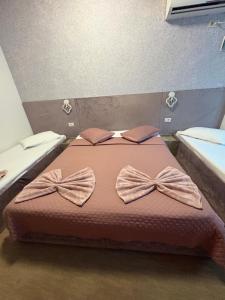 a bedroom with a bed with bows on it at Wednesday House in Constanţa