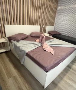 a bed with a stuffed animal on top of it at Wednesday House in Constanţa