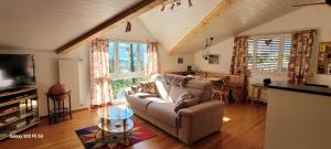a living room with a couch and a table at Ferienwohnung Bally in Brunnen