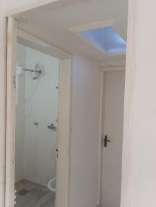 a bathroom with a shower and a blue ceiling at Hotel quarto 01 in Montes Claros