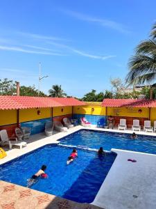 a group of people swimming in a swimming pool at Hotel Sociedad y Maristas in Tecolutla