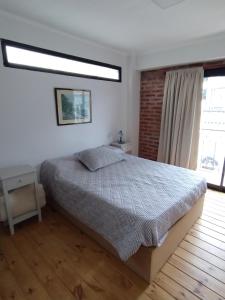 a bedroom with a bed and a large window at Deptos Boutique in San Salvador de Jujuy