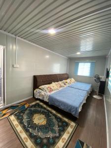 a bedroom with a bed and a rug on the floor at CTZ PAROH RIVER PARK in Jertih