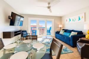 a living room with a table and a blue couch at La Internacional 313 in South Padre Island