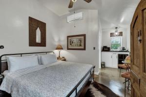 a bedroom with a bed and a kitchen at Tejas Suite Walking Distance to Main St! in Fredericksburg