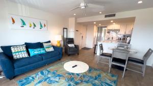 a living room with a blue couch and a kitchen at La Internacional 313 in South Padre Island