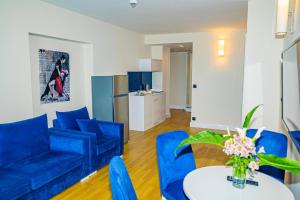 a living room with blue couches and a table at VIP HOTEL Sea view in batumi R in Batumi
