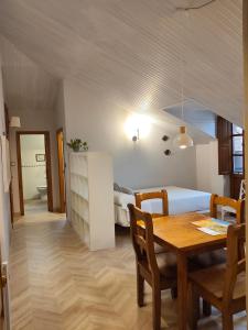 a bedroom with a dining room table and a bed at Apartamentos Los Hidalgos in Santillana del Mar