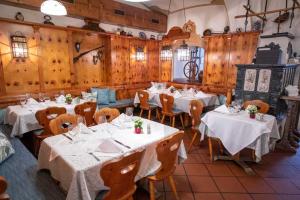 a dining room with white tables and wooden walls at Naschpark Dream Apartments! in Vienna