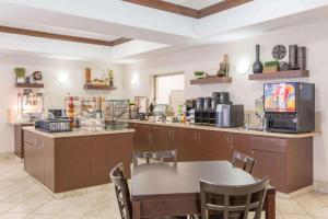 a dining room with a table and a kitchen at Canalta Wainwright in Wainwright