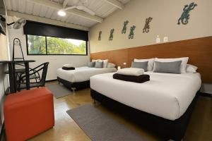 a hotel room with two beds and a window at Malibu loft hotel in Medellín