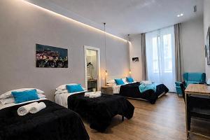 a hotel room with two beds and a mirror at Vatican Rome Suite in Rome