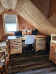 an attic room with a desk with a laptop on it at Cable Head Oceanview Casita in Saint Peters