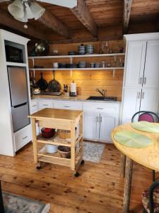 a kitchen with white cabinets and a wooden floor at Cable Head Oceanview Casita in Saint Peters