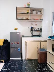 a kitchen with a refrigerator and a counter at Les studios meublés d'Angré in Abidjan +27 photos