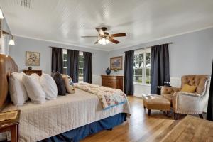 a bedroom with a bed and a ceiling fan at 7Cs Sunset Valley Ranch in Fredericksburg +40 photos