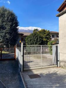 a gate in front of a house with a fence at CASA QUANZITO -Casa intera con giardino e parcheggio privato, ideale per famiglie in Dervio