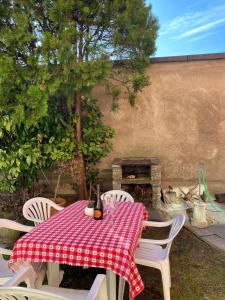 a table and chairs with a red and white checkered table cloth at CASA QUANZITO -Casa intera con giardino e parcheggio privato, ideale per famiglie in Dervio
