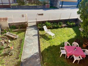 a patio with a table and chairs in a yard at CASA QUANZITO -Casa intera con giardino e parcheggio privato, ideale per famiglie in Dervio