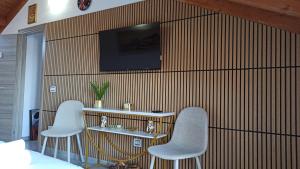 a room with two chairs and a television on a wall at Luna di miele in Albosaggia