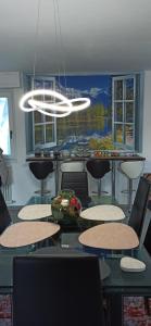 a dining room with tables and chairs and a chandelier at Luna di miele in Albosaggia