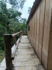 a wooden walkway leading down to a building at Cabañas Kapuy in Florencia