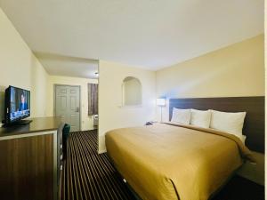 a hotel room with a bed and a flat screen tv at Suite 16 Motel in Gore +20 photos