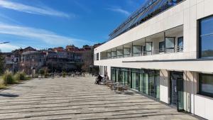 a large building with a walkway in front of it at Hotel ORJEN sport & pleasure in Trebinje