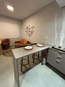 a kitchen with a table with two plates on it at Flat em Alphaville - Super Novo in Barueri