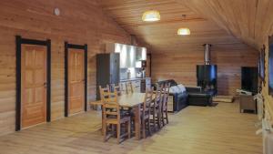 a kitchen and dining room with a table and chairs at Apart-hotel Schastye in Sheregesh