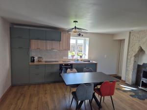 a kitchen with a table and chairs in a room at La clé des songes in Cellefrouin