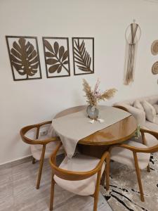 a dining room with a table and two chairs at Modern 3BR Apartment - Heart of Sheikh Zayed - Gated Compound in Sheikh Zayed