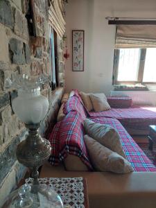 a living room with a couch and a bed at Evenos Stone Villa in Ierapetra