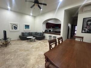 a living room with a table and a couch at Spacious 3 bedroom Condo by Mamitas beach in Playa del Carmen