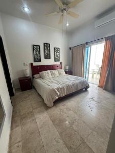 a bedroom with a bed and a ceiling fan at Spacious 3 bedroom Condo by Mamitas beach in Playa del Carmen +13 photos