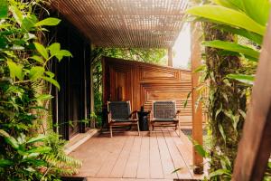 two chairs sitting on the porch of a house at Bambuda Lodge in Bocas Town