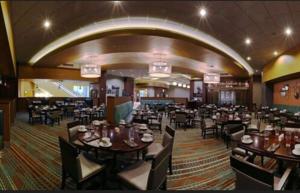 a dining room with tables and chairs in a restaurant at Apache Casino Hotel in Lawton
