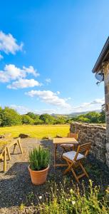 a picnic table and a bench in a field at Haytor Rocks, Dartmoor escape in Bovey Tracey