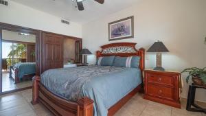 a bedroom with a bed and a dresser and a mirror at Vacation Paradise Relaxing Ocean Front Condo in Puerto Peñasco +22 photos