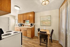 a kitchen with a table and a stove at Red Ivy #5 in Boise +19 photos