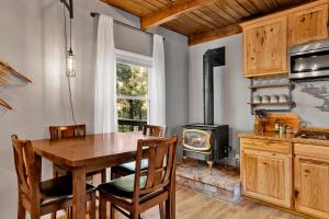 a kitchen with a table and a wood stove at The Summit at Sherwood #618 in Big Bear City
