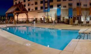 a large blue swimming pool in front of a building at Apache Casino Hotel in Lawton