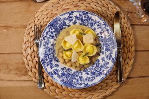 a blue and white bowl of soup with pasta and cheese at Le Conche country house in Villamaina +28 photos