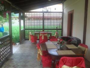 a dining room with tables and chairs and a table and chairs at Nopti de Vara Transfăgărășan in Căpăţîneni-Pămînteni