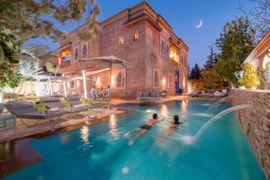 two people in a swimming pool in a house at Luxury Private Villa Taj Sofia & Spa in Marrakesh +144 photos