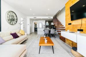 a living room with a couch and a table at Casa Phillips in Orihuela Costa
